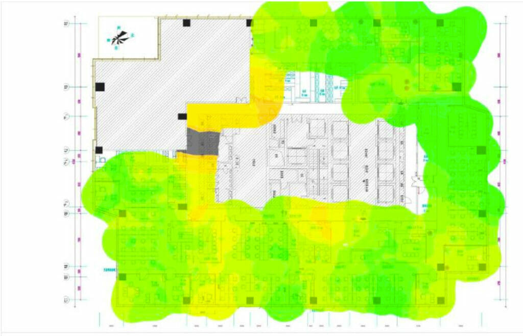 Building floor plan with an overlaid heatmap illustrating Wi-Fi analysis, showing signal strength that ranges from green (strong) to yellow (moderate) coverage throughout the space.
